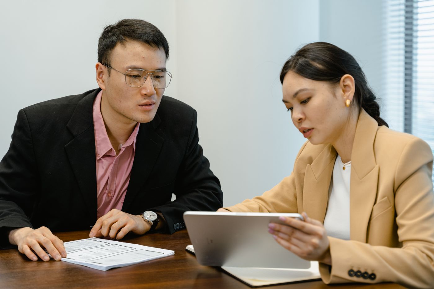 Two managers reviewing a document on a tablet