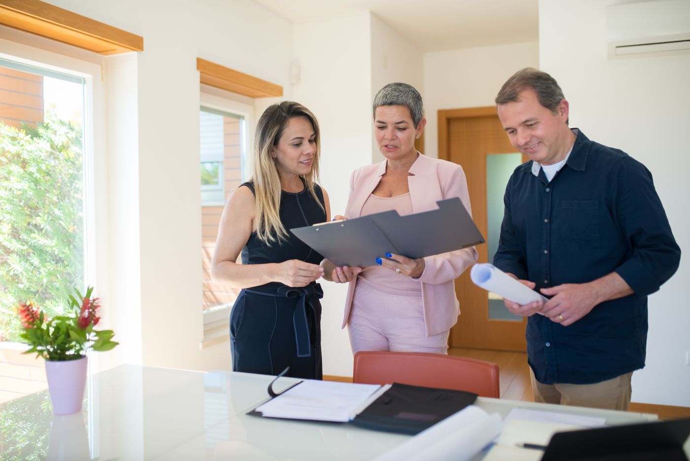 A property manager going through a tenancy file with two colleagues